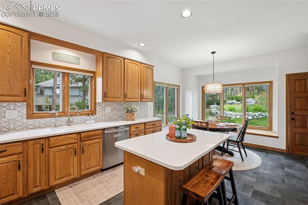 Image 13 of 39: Kitchen featuring backsplash, recessed lighting, a center island, dishwashe