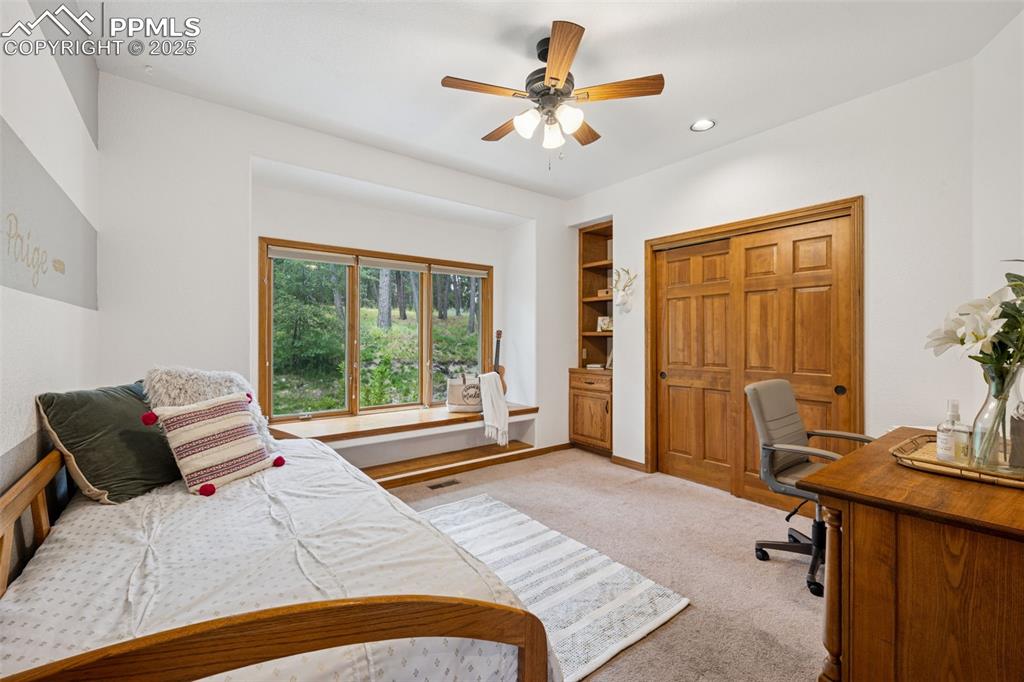 Image 23 of 39: Bedroom featuring a desk, light colored carpet, recessed lighting, and ceil