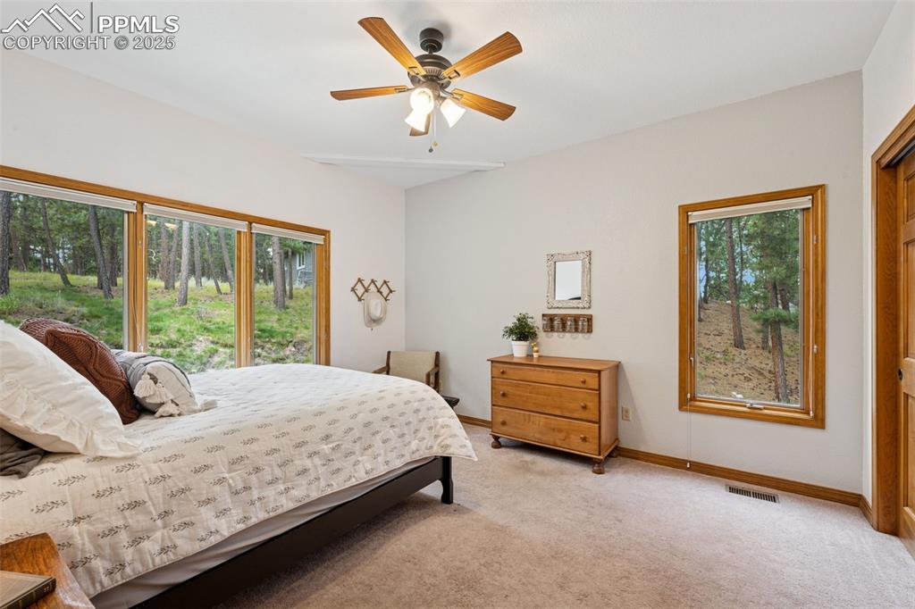 Image 26 of 39: Bedroom featuring light colored carpet and a ceiling fan