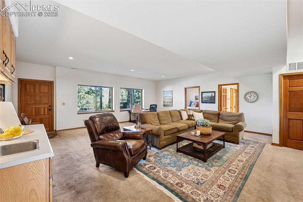 Image 30 of 39: Living area featuring light carpet and recessed lighting