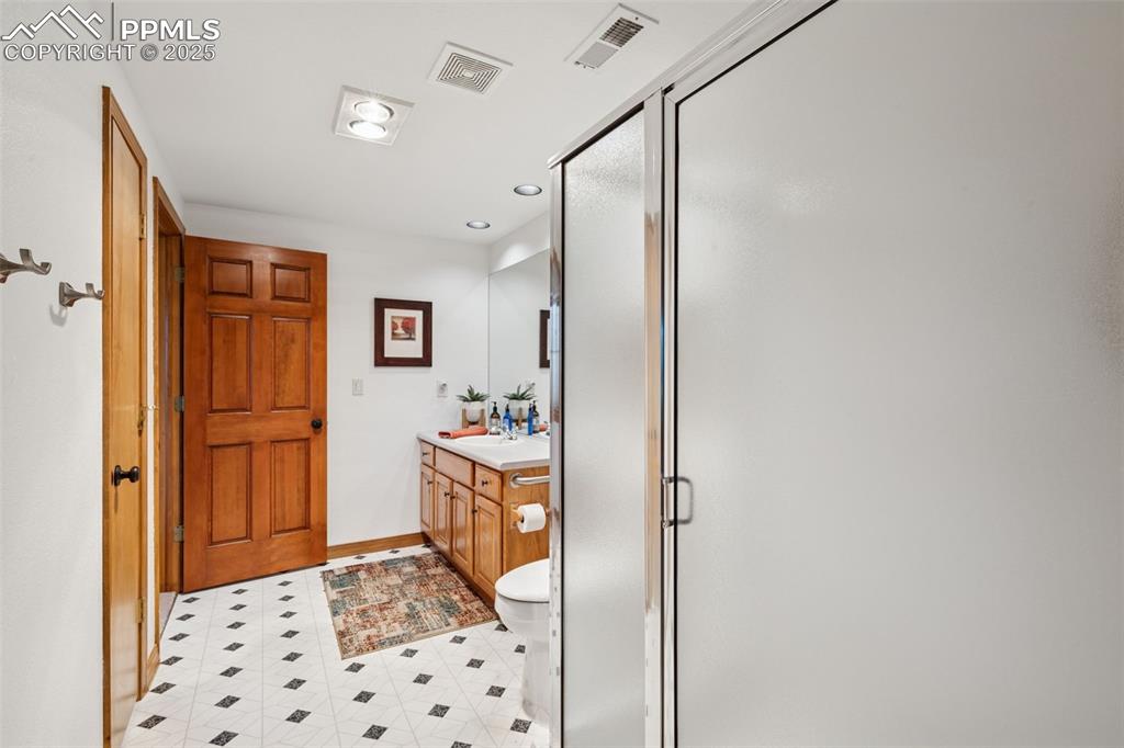 Image 33 of 39: Full bath featuring vanity, a stall shower, and recessed lighting
