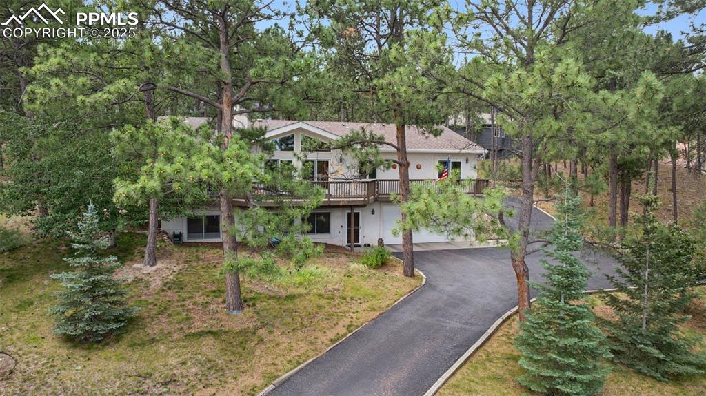 Image 4 of 39: View of front of property featuring asphalt driveway