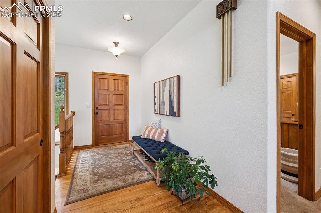 Image 5 of 39: Entryway with light hardwood oak floors and recessed lighting