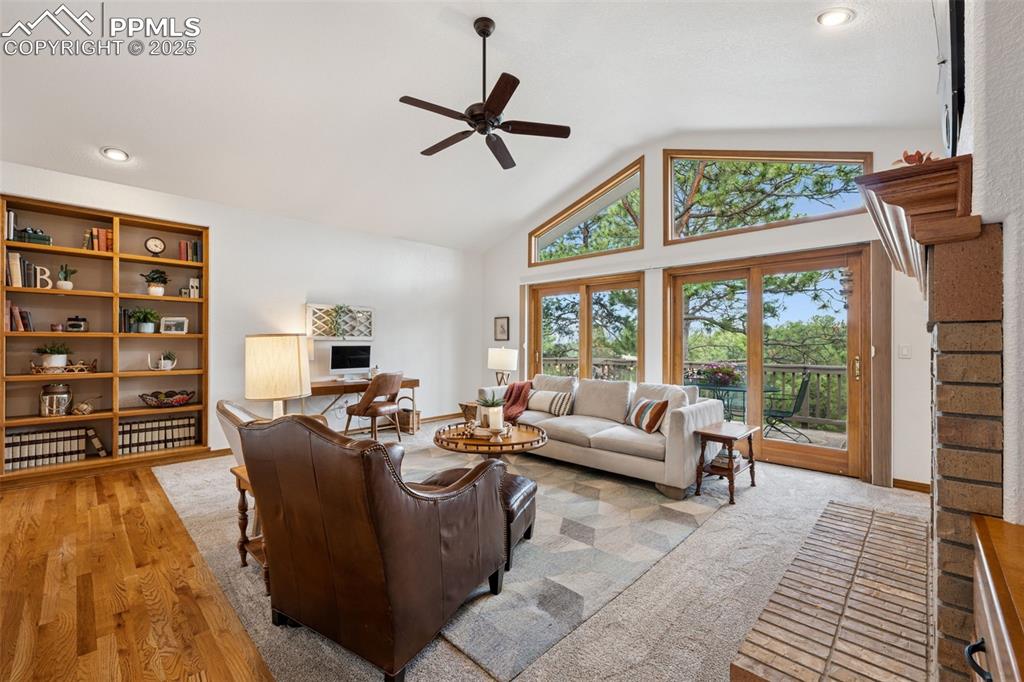Image 7 of 39: Living room featuring high vaulted ceiling and ceiling fan