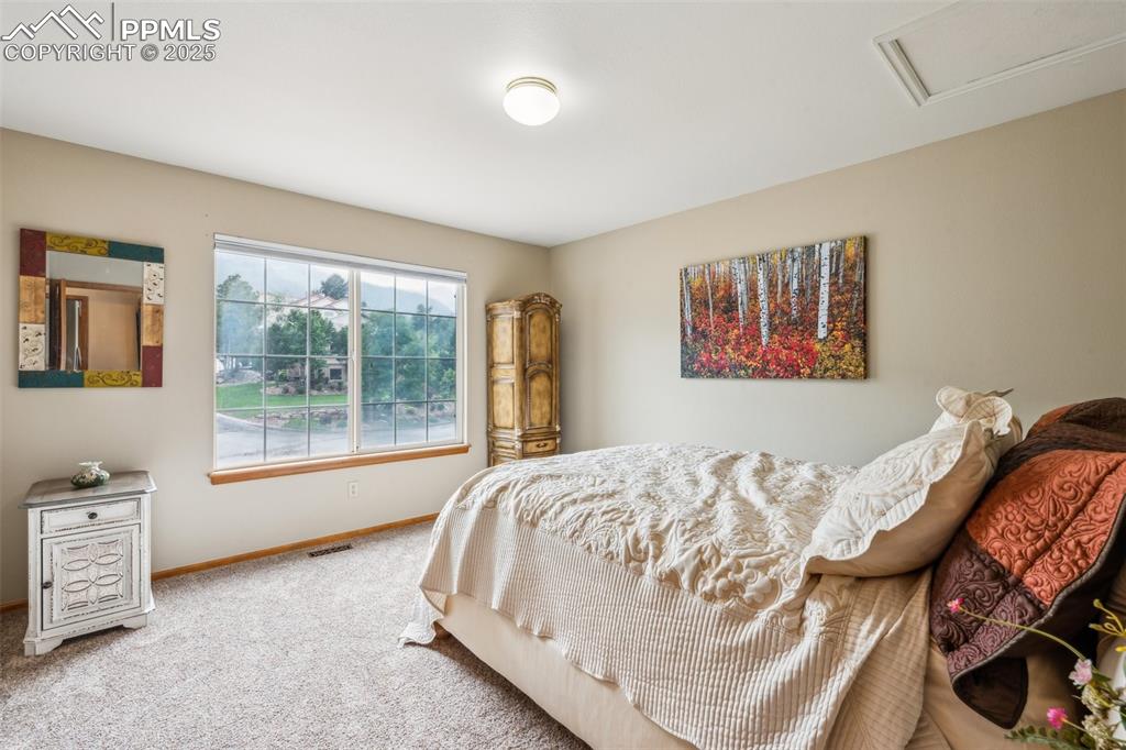 Image 30 of 43: Carpeted bedroom with baseboards and attic access
