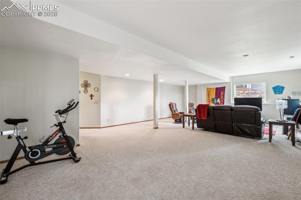 Image 33 of 43: Carpeted living room featuring baseboards and recessed lighting