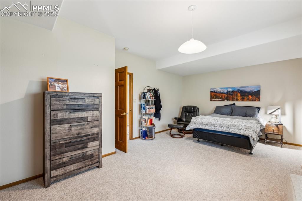 Image 35 of 43: Bedroom with light carpet and baseboards