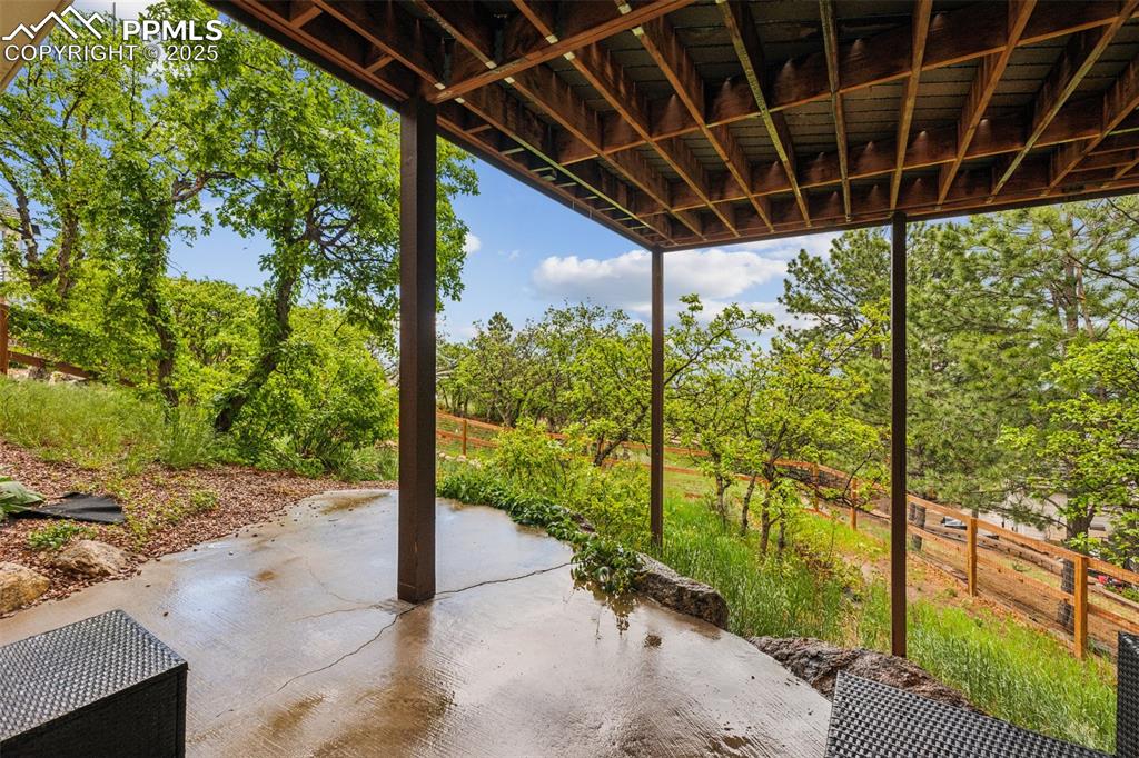 Image 40 of 43: View of patio / terrace with view of wooded area
