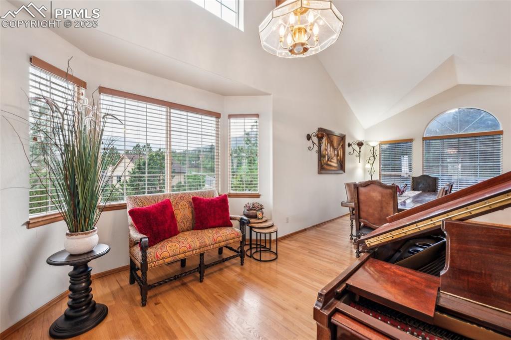 Image 7 of 43: Bedroom featuring multiple windows, a chandelier, wood finished floors, and
