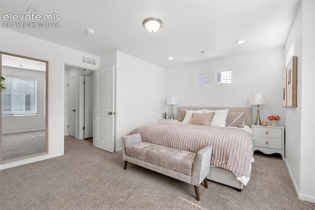 Image 20 of 35: Plush carpet flooring, recessed lighting, and a neutral color palette
*pho