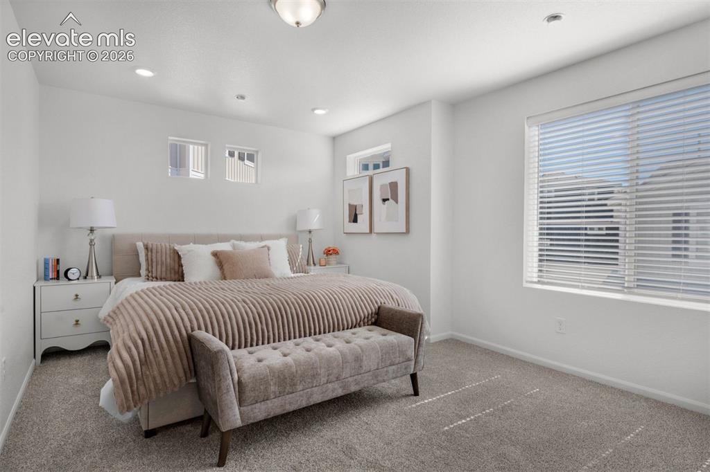 Image 21 of 35: Recessed lighting, large window with blinds, two high-set transom windows, 