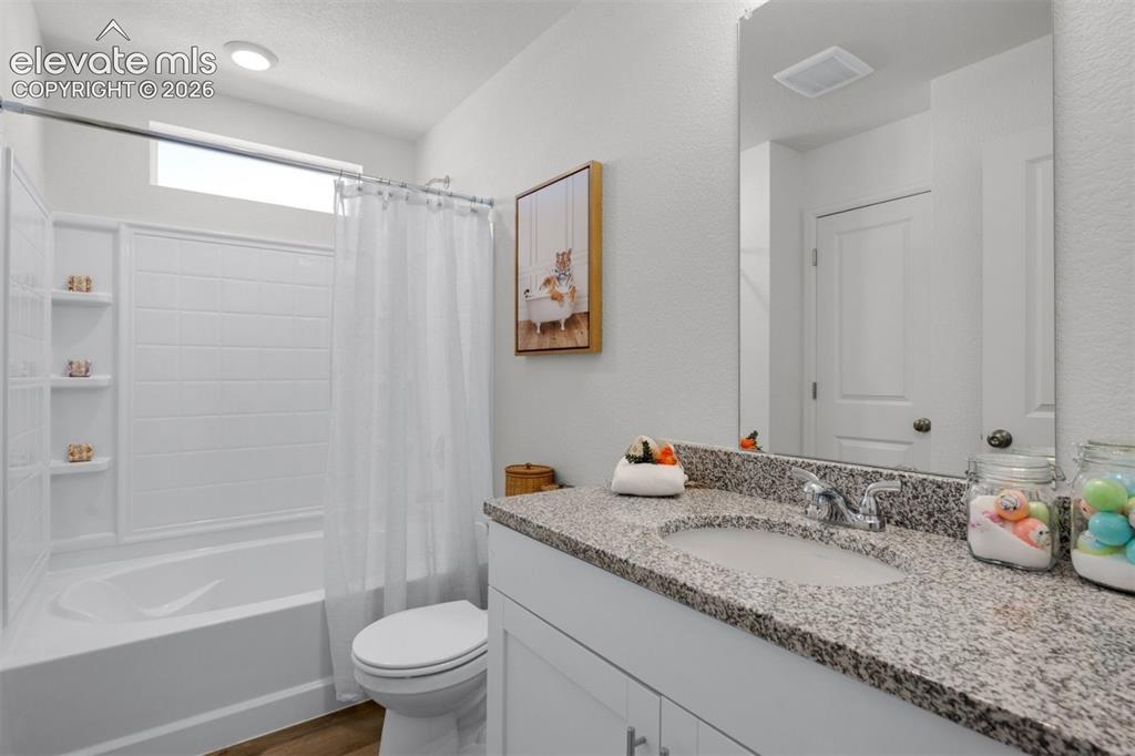 Image 23 of 35: White shower/tub combination with integrated shelving, transom window, rece