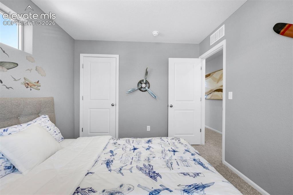 Image 24 of 35: Recessed window providing natural light, two panel interior doors, and neut