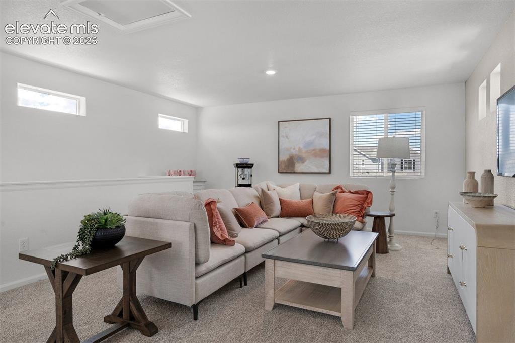Image 28 of 35: Carpeted flooring with multiple windows, recessed lighting, and a partial w