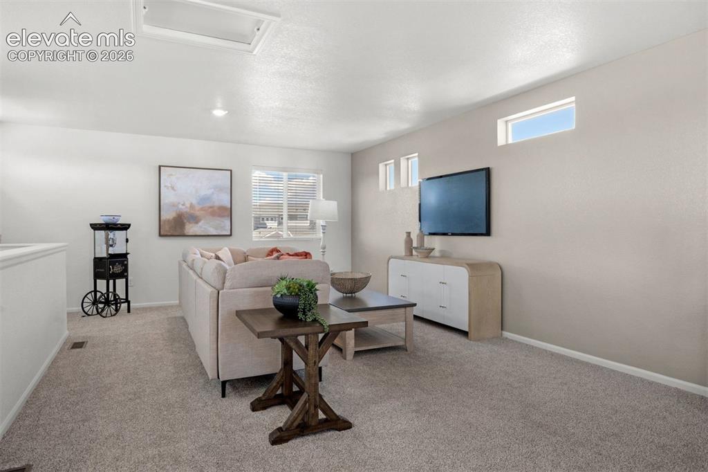 Image 31 of 35: Recessed lighting, light-toned carpeting, transom window, rectangular windo