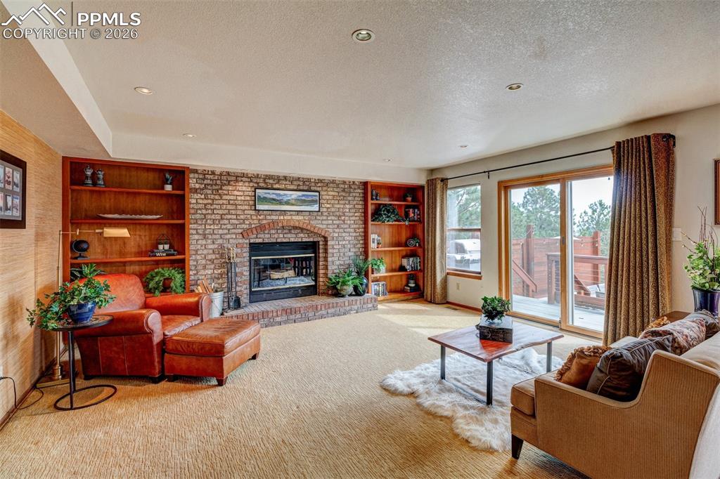 Image 17 of 39: Family room opens to deck and a fabulous patio
