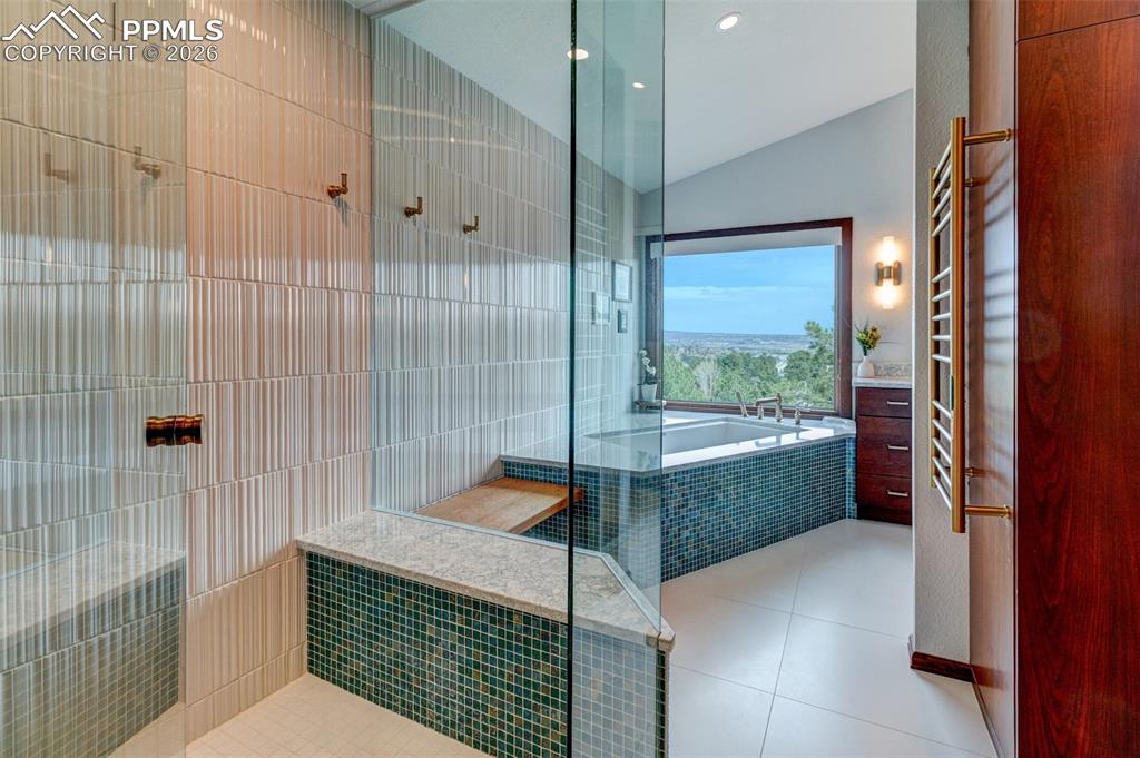 Image 27 of 39: Shower and soaking tub. Heated towel rack on right.