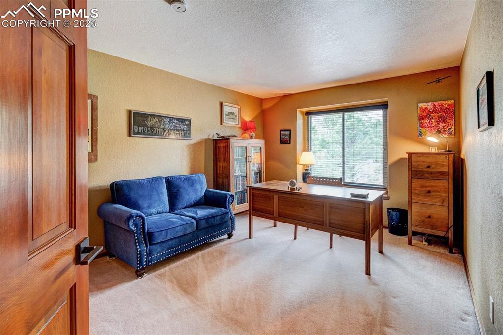 Image 32 of 39: Upper level bedroom currently used for an office