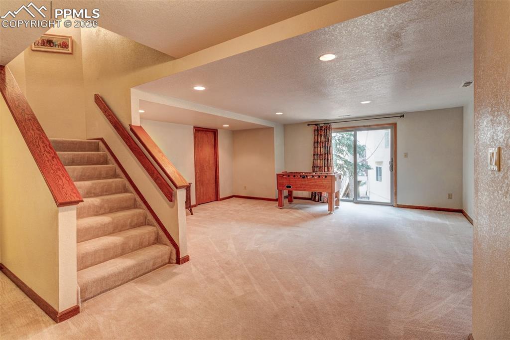 Image 35 of 39: Lower level rec room with walk out