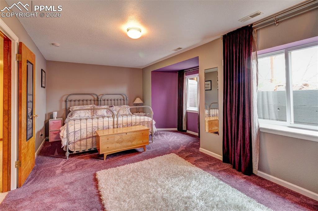 Image 37 of 39: Lower level guest bedroom