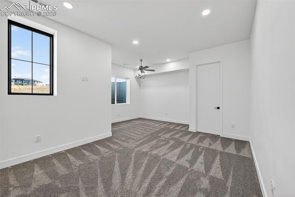 Image 40 of 44: Large basement bedroom with walk in closet and sitting area