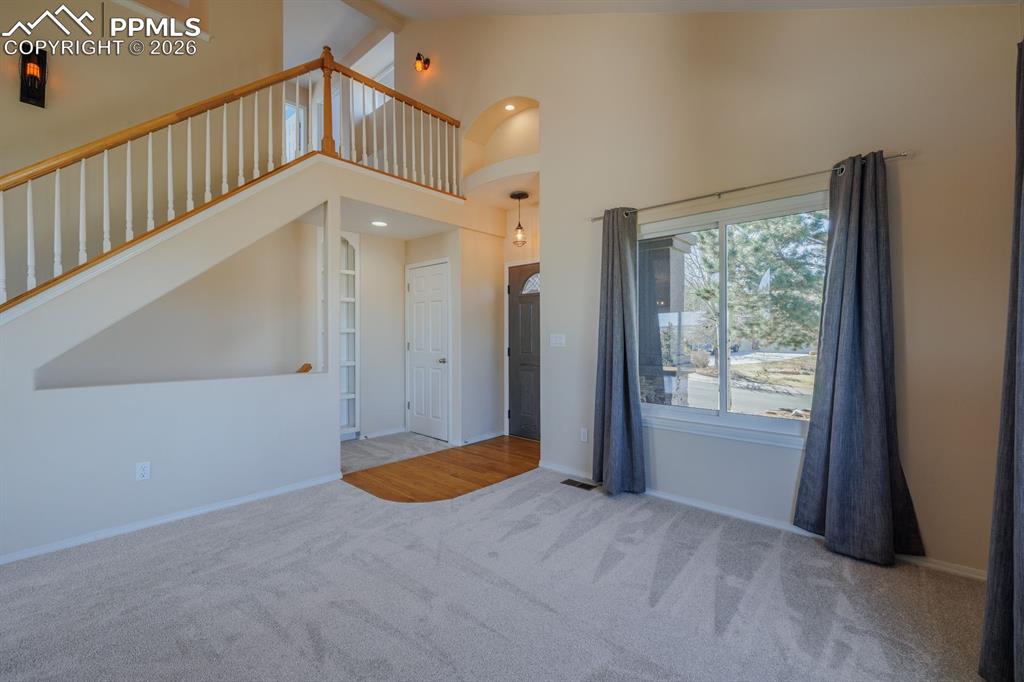 Image 14 of 49: View of staircase to upper level from the living room
