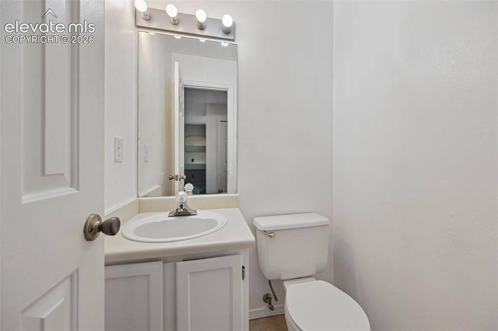 Image 23 of 25: White vanity with an integrated sink and base cabinetry, complemented by a 