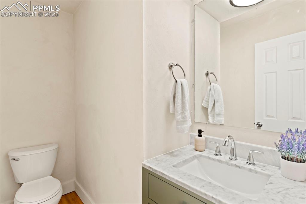 Image 11 of 29: Updated bathroom on main level across from staircase