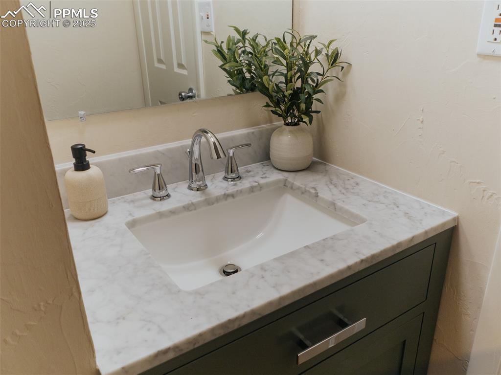 Image 12 of 29: Main level half bathroom with upgraded countertops