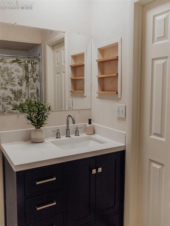 Image 16 of 29: Built-in shelving in upper level bathroom