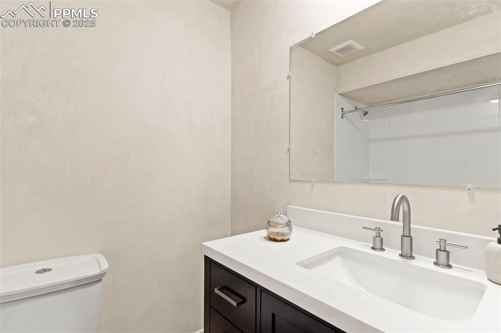 Image 17 of 29: Built-in shelving in upper level bathroom