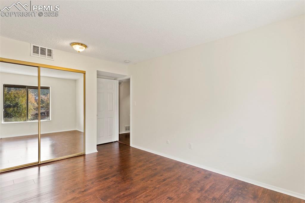 Image 19 of 29: Primary bedroom with glass door closets