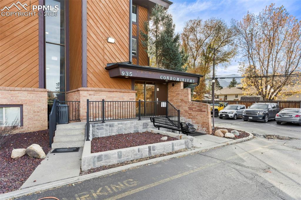 Image 26 of 29: Main building entrance on Northwest side of the building. Guest parking in 