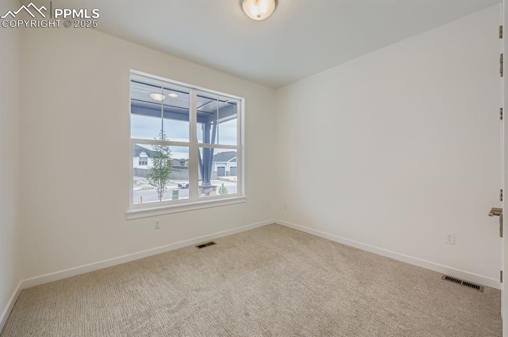 Image 12 of 28: Unfurnished room featuring light colored carpet and baseboards