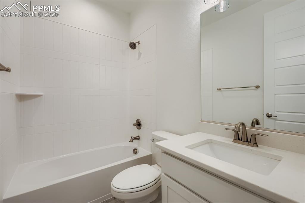Image 13 of 28: Full bathroom featuring tub / shower combination and vanity