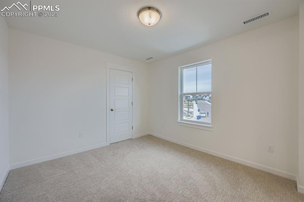Image 19 of 28: Spare room with light colored carpet and baseboards
