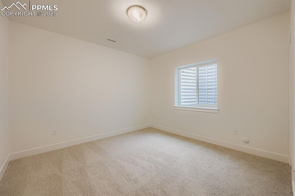 Image 24 of 28: Spare room featuring light colored carpet and baseboards
