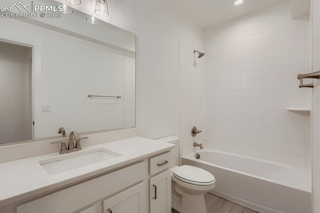 Image 25 of 28: Bathroom with shower / bathtub combination, vanity, and recessed lighting
