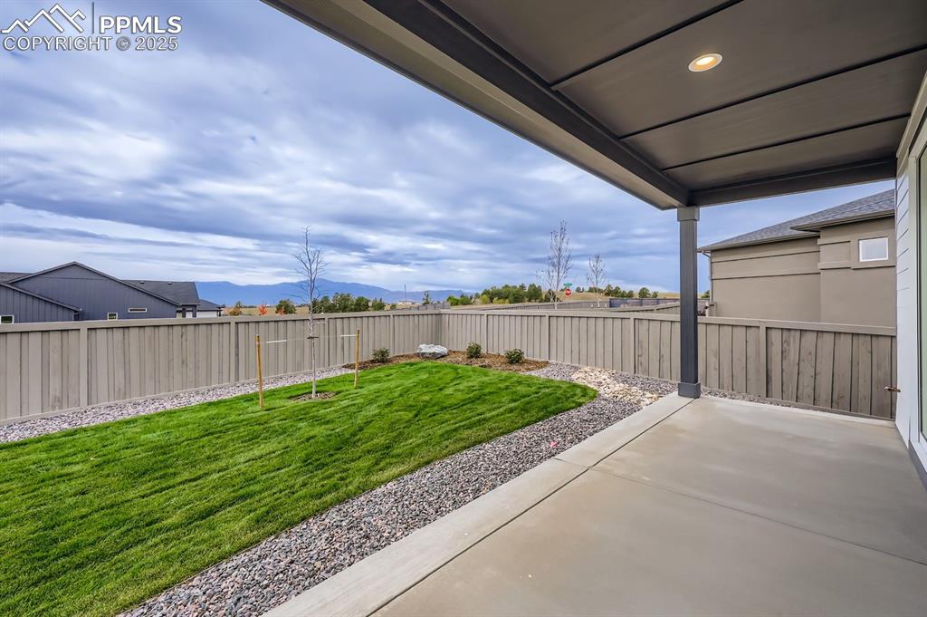 Image 26 of 28: Fenced backyard featuring a patio area and a mountain view