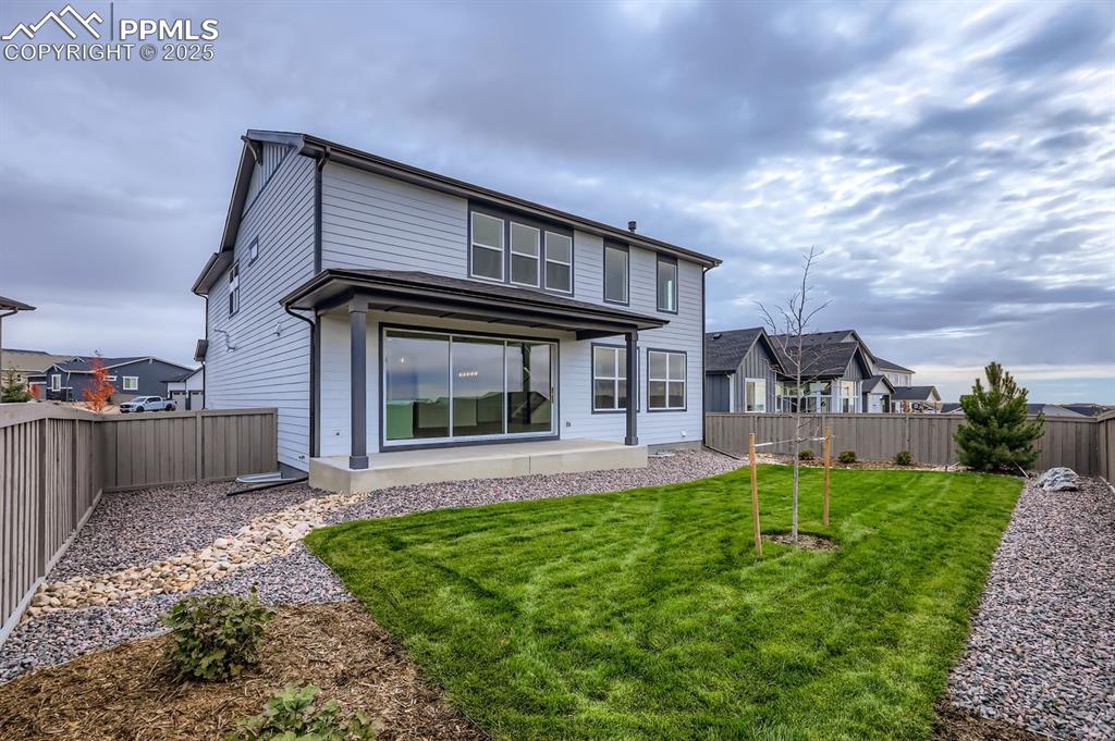 Image 28 of 28: Rear view of house with a fenced backyard and a patio area