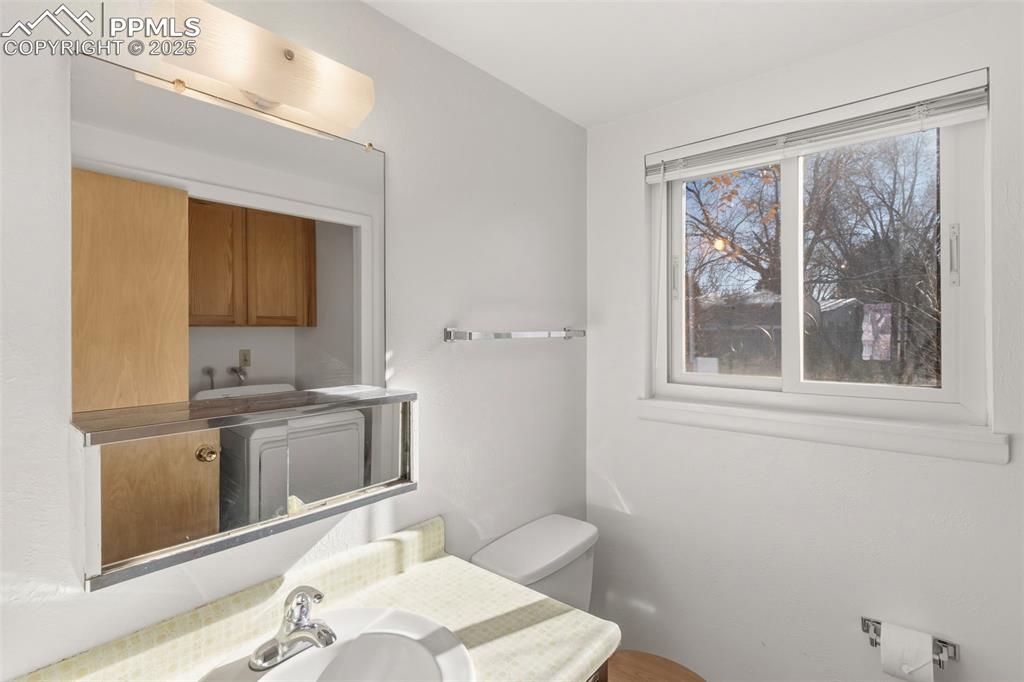 Image 13 of 32: Main level bathroom and laundry