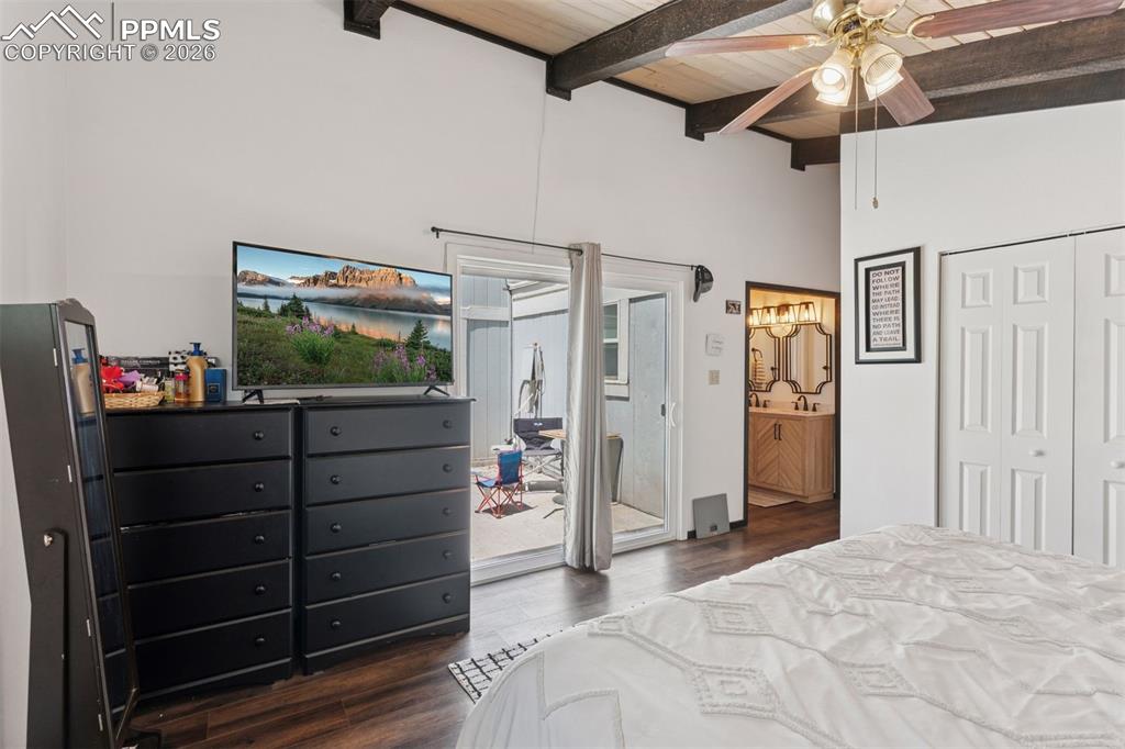 Image 13 of 49: Bedroom w/sliding glass door to patio & en-suite bathroom access