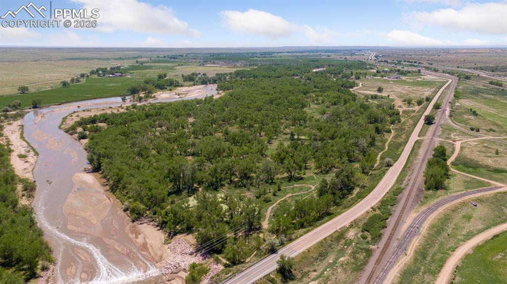 Image 2 of 49: Aerial view highlighting Fountain Creek frontage, mature cottonwood corrido