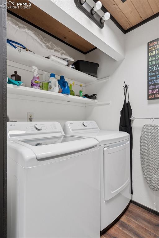 Image 21 of 49: Laundry area featuring washer and dryer with built-in shelving for storage