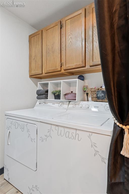 Image 34 of 49: Laundry room with cabinets for storage