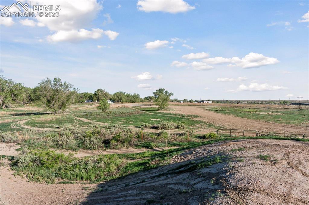 Image 40 of 49: Vast open pastureland before the trail system, highlighting the diversity o