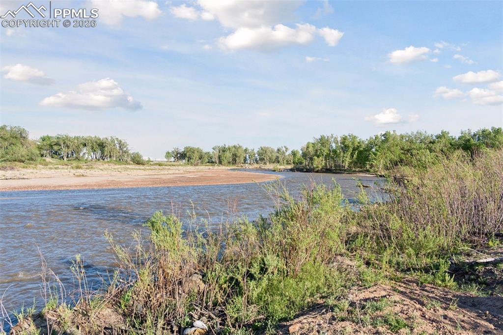 Image 46 of 49: Peaceful creekside views where open water, sandy banks, and riparian habita