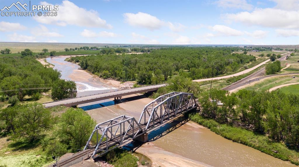 Image 6 of 49: View near a corner of the property, illustrating Fountain Creek, adjacent t