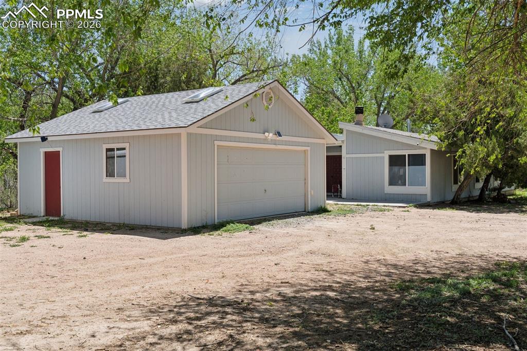 Image 8 of 49: Exterior view of the 5-bedroom, 2.5-bath single-family residence with detac