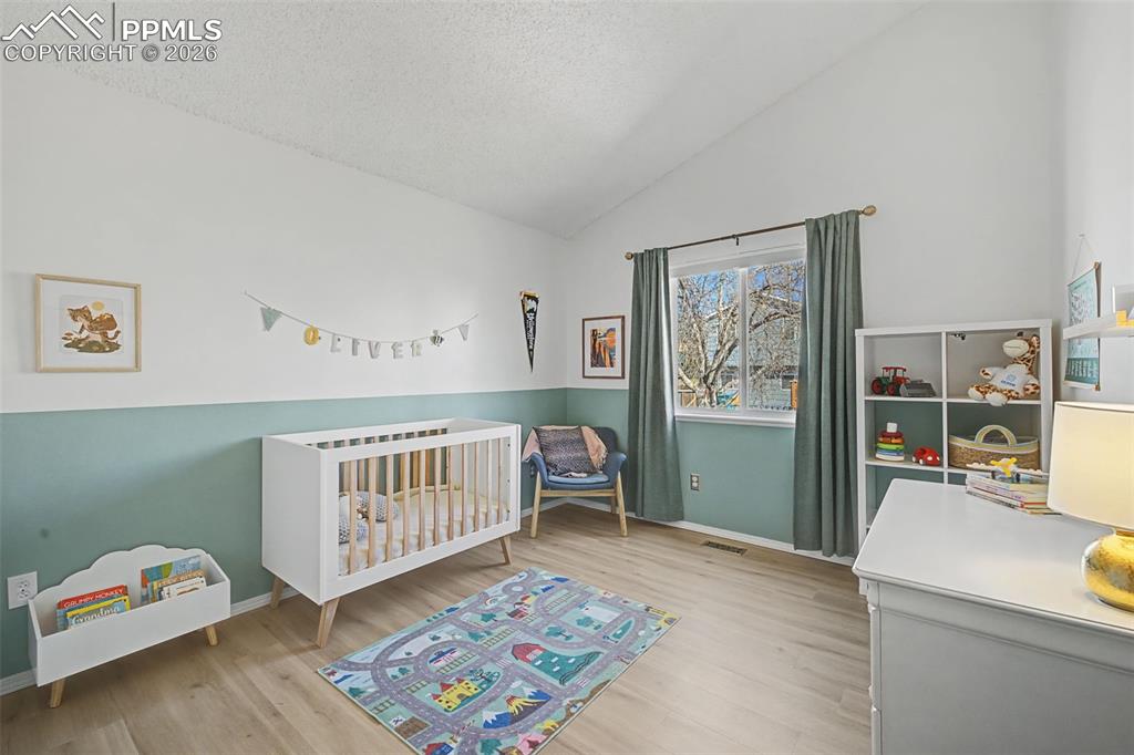 Image 30 of 41: Bedroom 2 on upper level. Window faces the backyard